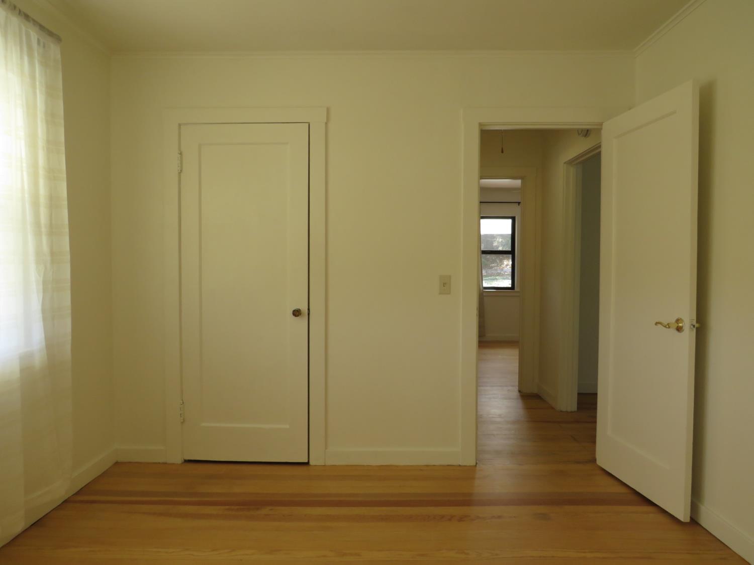 320 Pleasant Street Colfax, CA 95713 - Photo 16 of 49 an empty room with wooden floor and windows
