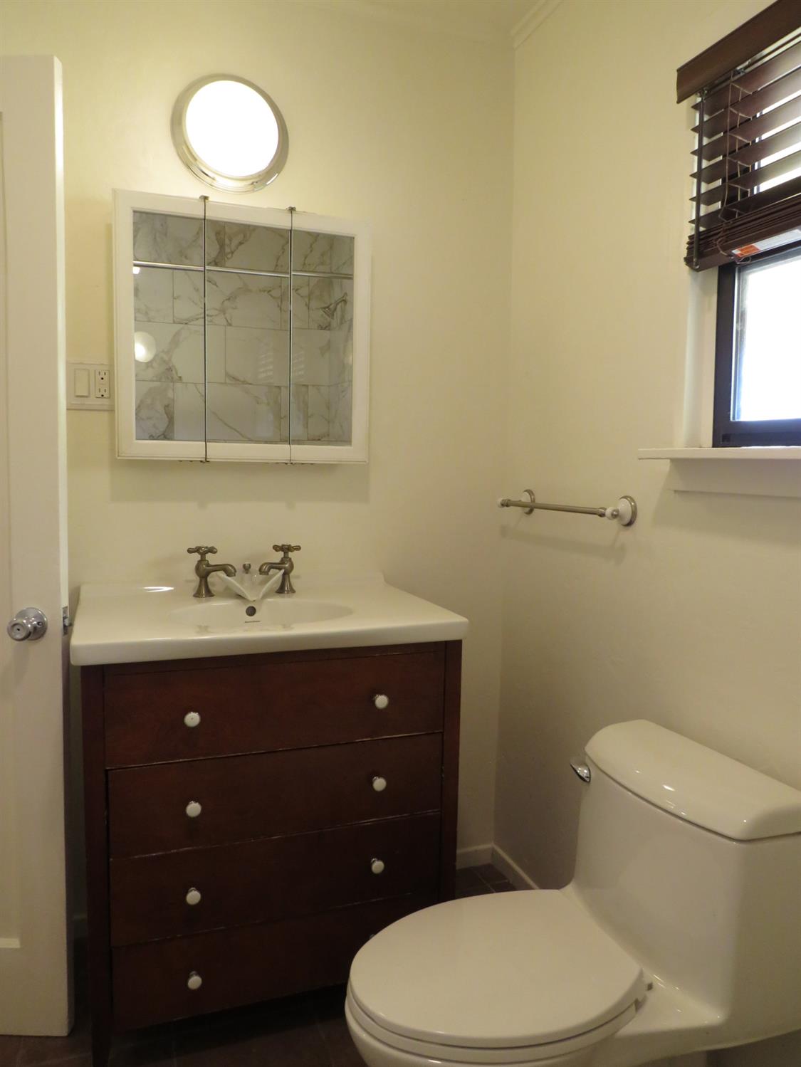 320 Pleasant Street Colfax, CA 95713 - Photo 18 of 49 a bathroom with a toilet sink vanity and mirror