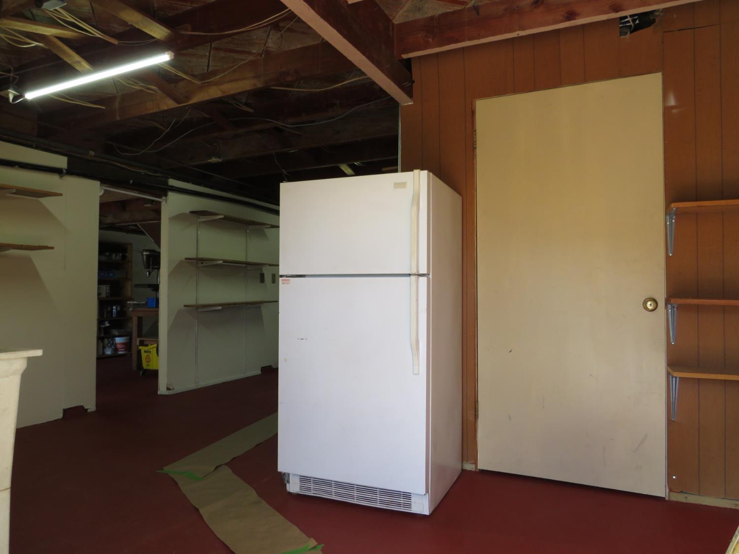 320 Pleasant Street Colfax, CA 95713 - Photo 45 of 49 a view of a refrigerator in kitchen and an empty room