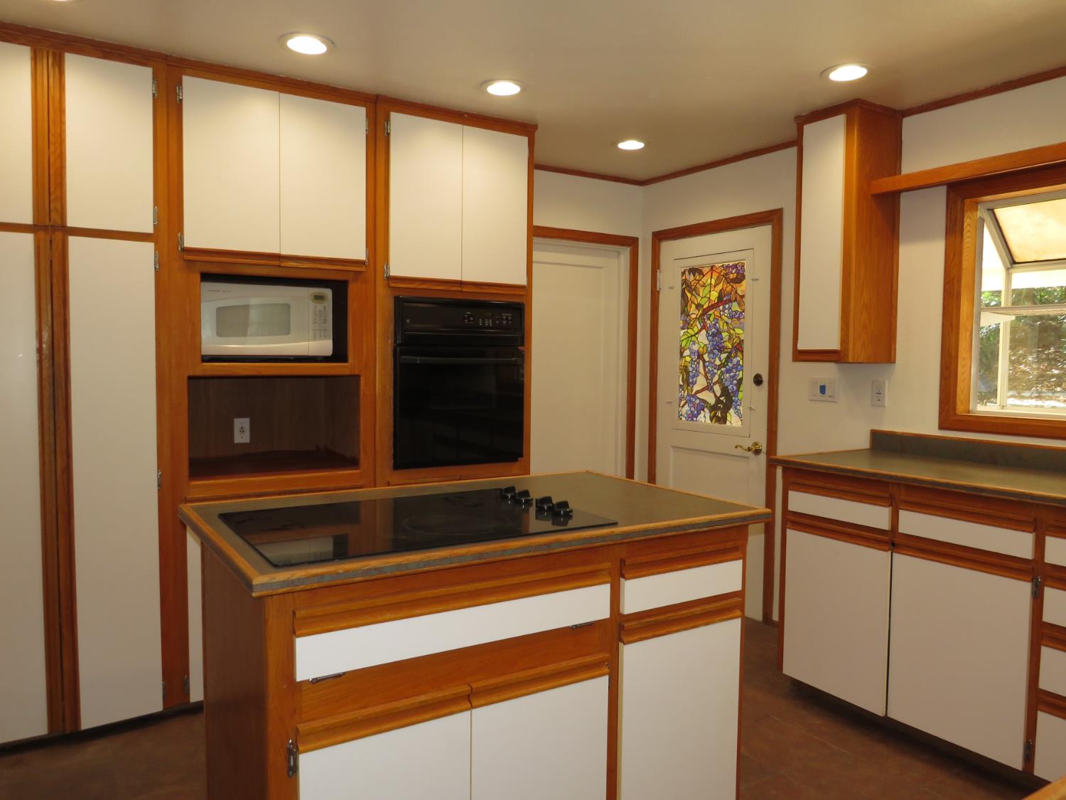320 Pleasant Street Colfax, CA 95713 - Photo 9 of 49 a kitchen with stainless steel appliances granite countertop cabinets and wooden floor
