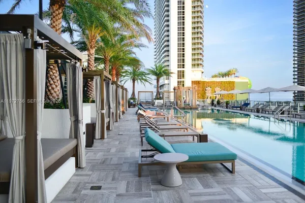 a balcony with chairs and a table
