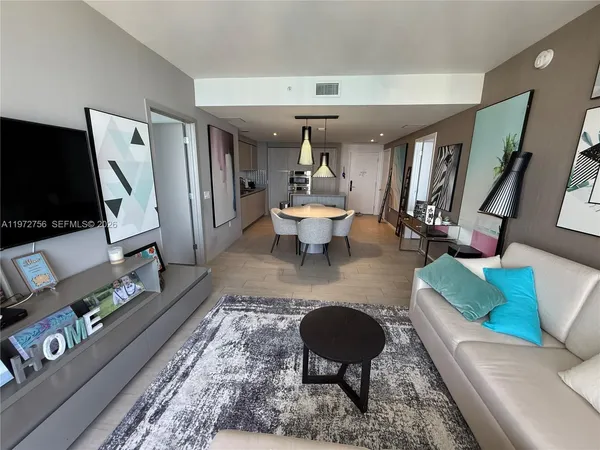 a living room with furniture and a flat screen tv