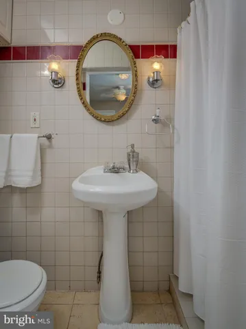 a bathroom with a sink toilet and mirror