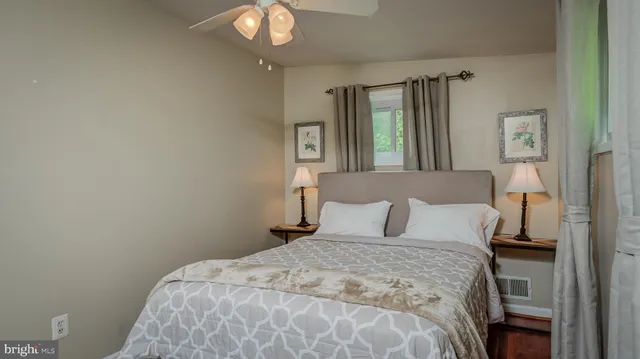 a bedroom with a bed and a mirror