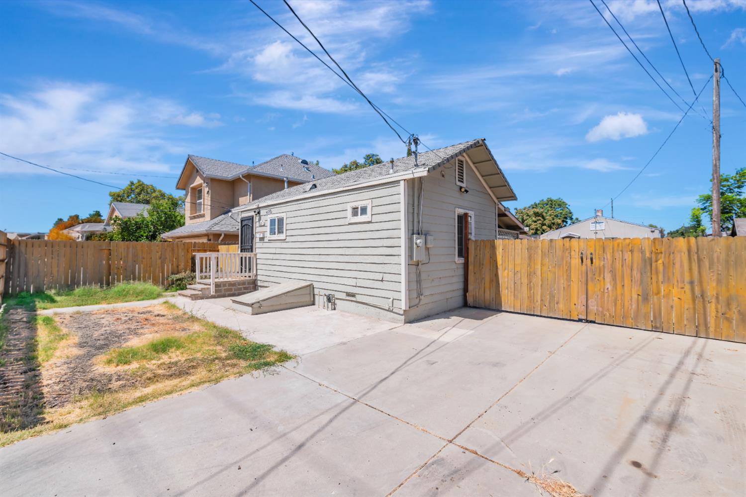 536 Locust Street Lodi, CA 95240 - Photo 2 of 18 a view of a house with a small yard and wooden fence