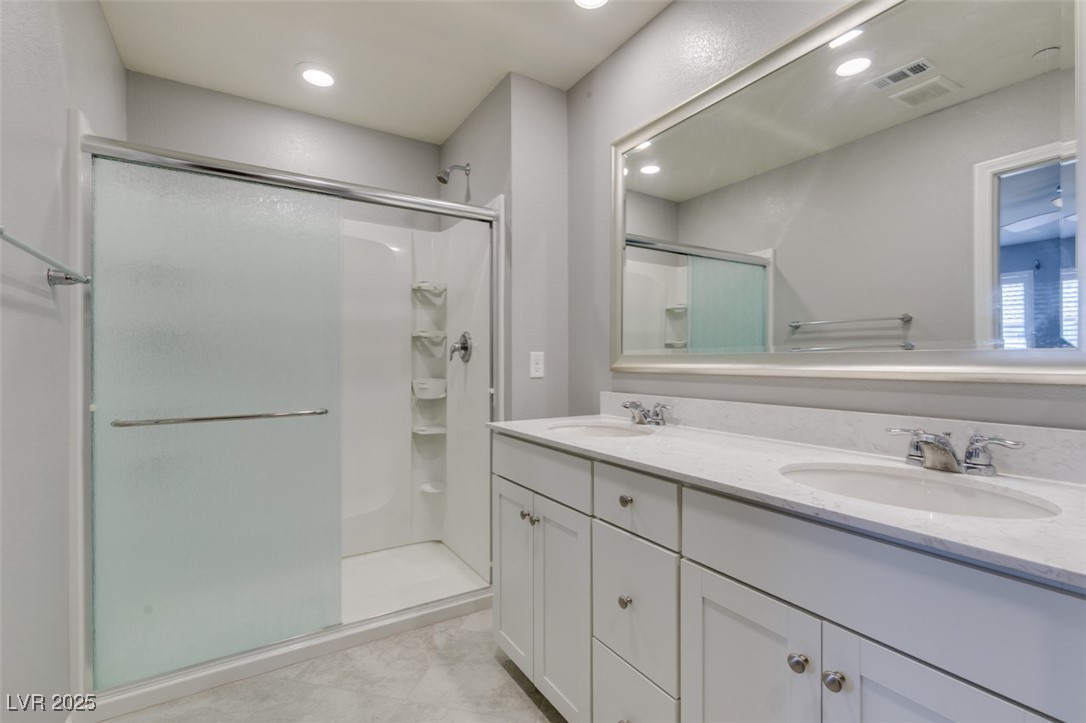 2870 Turnstone Ridge Street Henderson, NV 89044 - Photo 37 of 50 Bathroom with a shower stall, double vanity, and recessed lighting