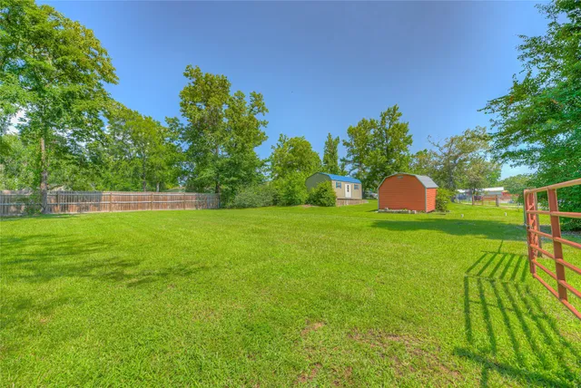 a view of a field of grass and trees