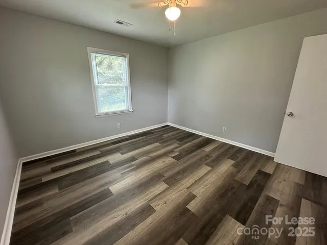 en empty room with wooden floor