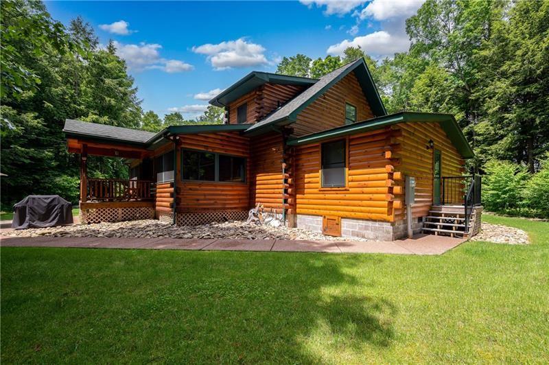 3906 Master Road Emlenton, PA 16373 - Photo 11 of 31 a front view of a house with a garden and trees
