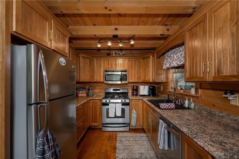 3906 Master Road Emlenton, PA 16373 - Photo 7 of 31 a kitchen with stainless steel appliances granite countertop a refrigerator a stove a sink and a microwave