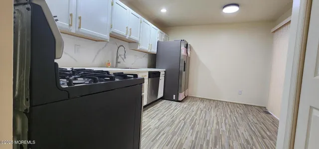 a kitchen with stainless steel appliances a refrigerator and a stove