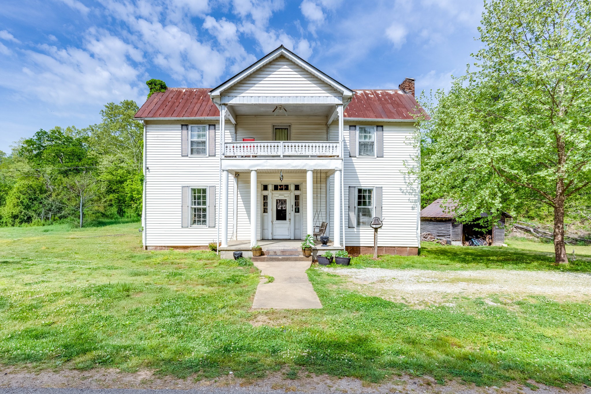 2012 Hoovers Road Duck River, TN 38454 - Photo 1 of 48 a front view of a house with a yard and garage