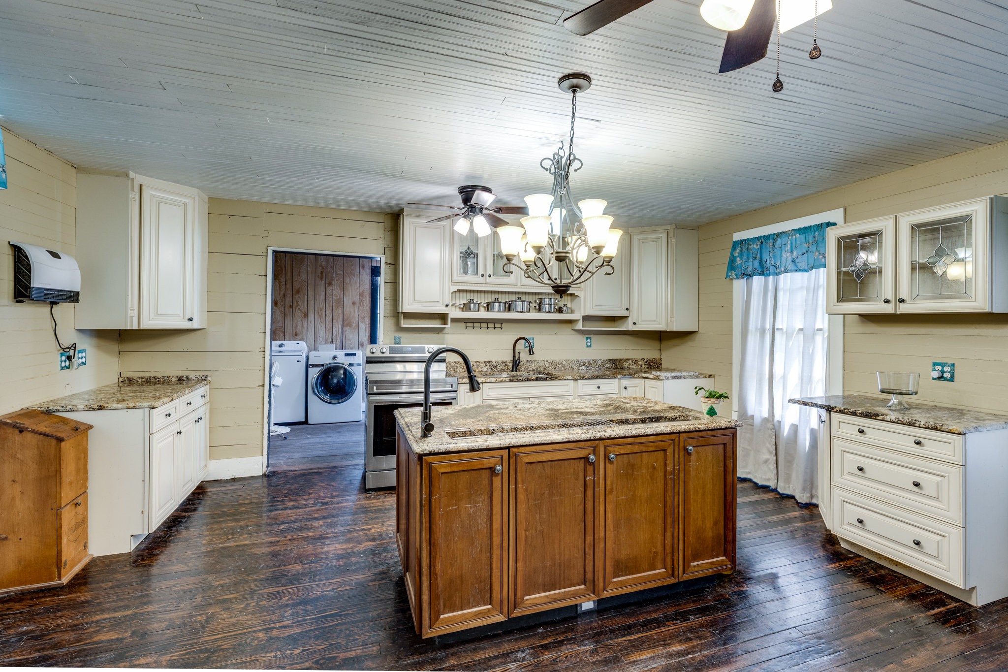 2012 Hoovers Road Duck River, TN 38454 - Photo 15 of 48 a kitchen with kitchen island granite countertop wooden floors and white cabinets