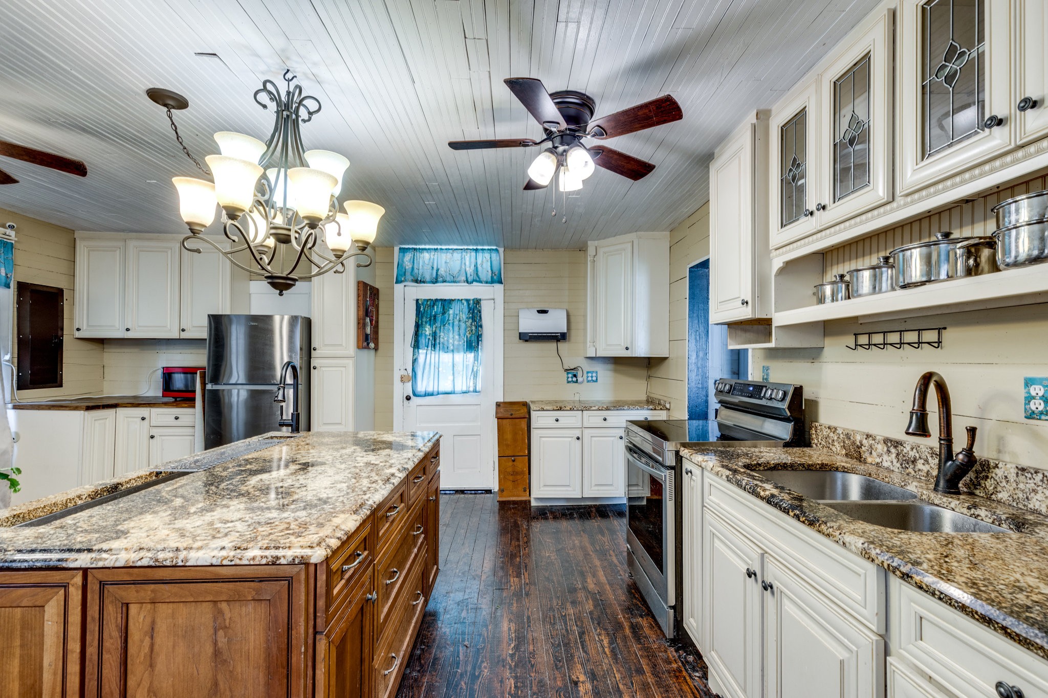 2012 Hoovers Road Duck River, TN 38454 - Photo 18 of 48 a kitchen with kitchen island granite countertop stainless steel appliances a sink stove and cabinets