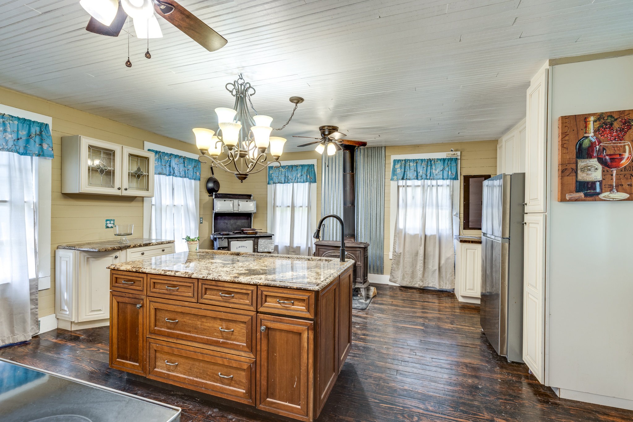 2012 Hoovers Road Duck River, TN 38454 - Photo 19 of 48 a room with kitchen island granite countertop furniture a fireplace and a chandelier