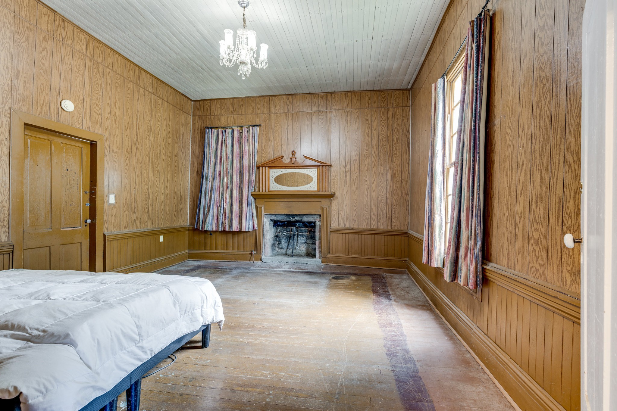 2012 Hoovers Road Duck River, TN 38454 - Photo 22 of 48 a spacious bedroom with a bed and a chandelier