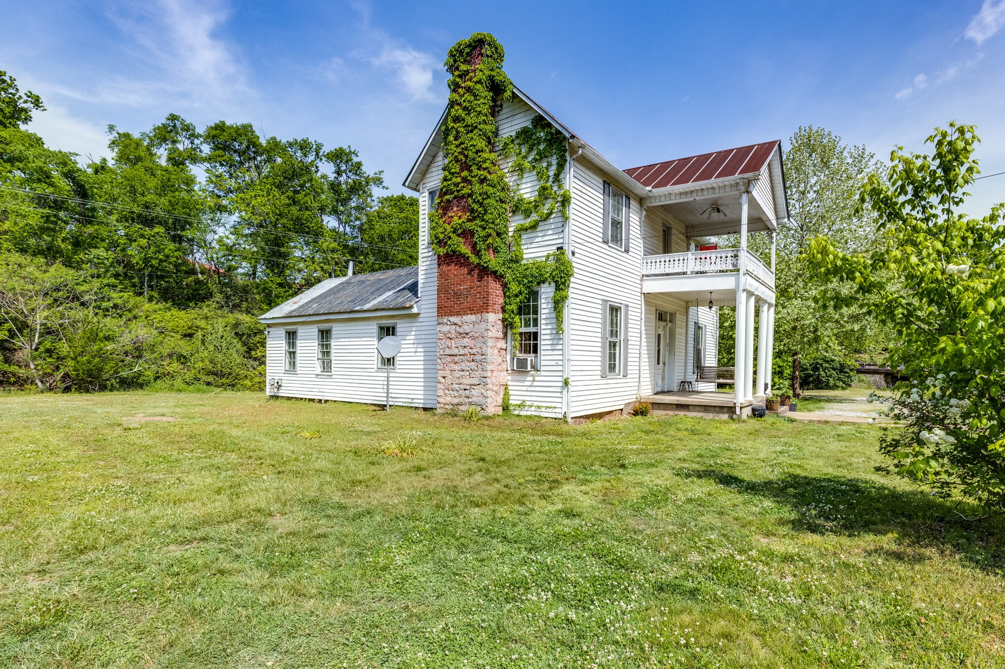 2012 Hoovers Road Duck River, TN 38454 - Photo 6 of 48 a front view of a house with a garden
