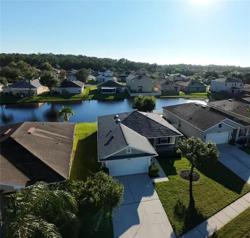 an aerial view of a house with a lake view