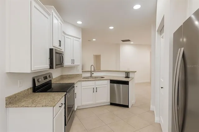 a kitchen with a sink stove and cabinets