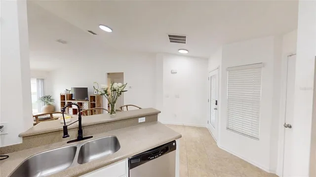 a kitchen with a sink and a refrigerator