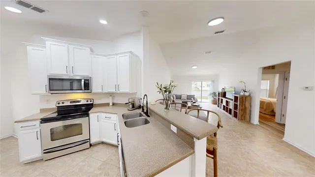 a kitchen with a stove a microwave and refrigerator