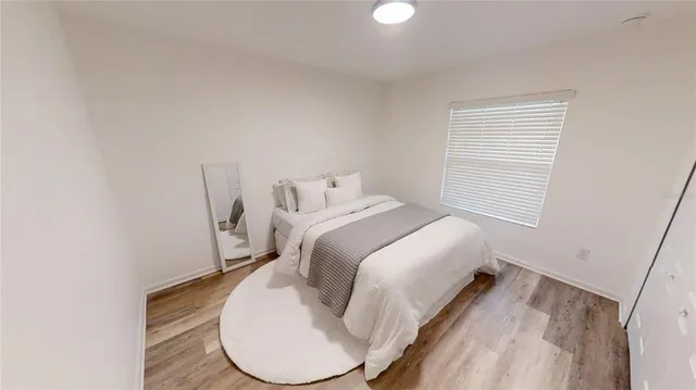 a bed room with a bed and a window