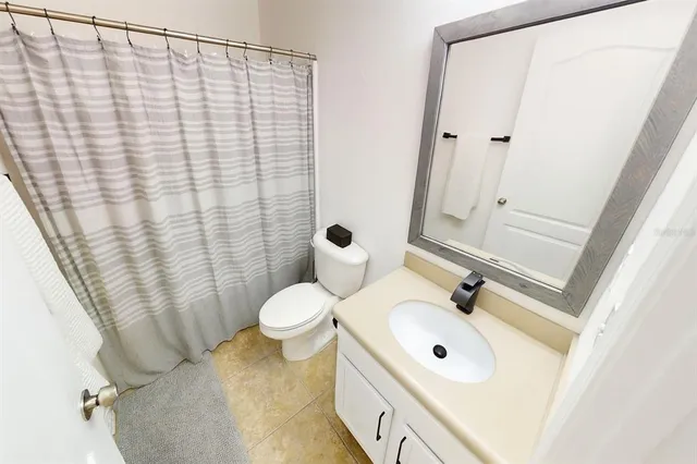 a bedroom with a bed and a tv