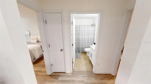 a bedroom with a bed and a white wall