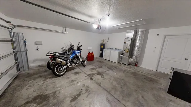 an aerial view of a house with a garden and lake view