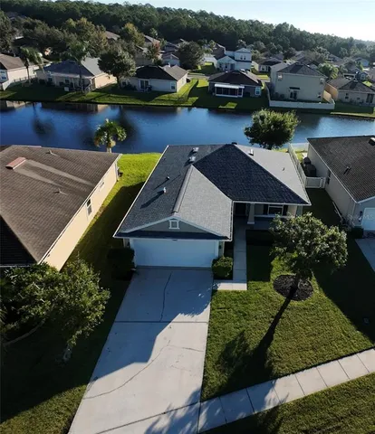 an aerial view of a house with garden space and street view