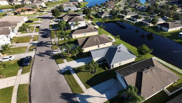 an aerial view of residential houses with outdoor space