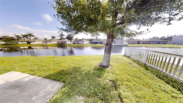 a view of a lake with houses in the back