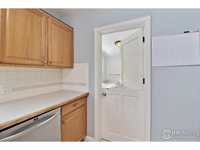 a view of a kitchen with white cabinets