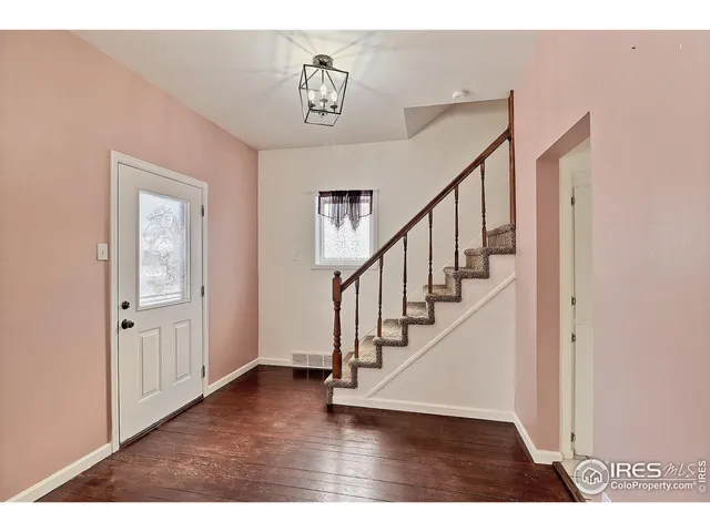 a view of an entryway with wooden floor