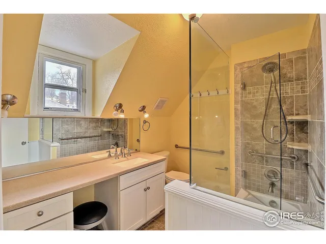 a bathroom with a sink a mirror and a shower
