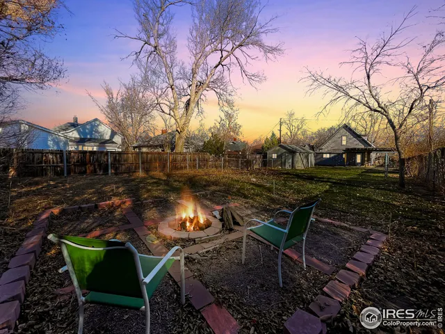 a view of a backyard with sitting area