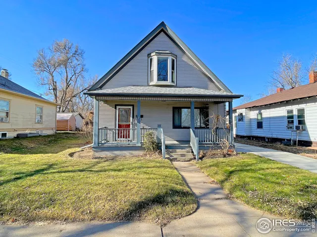 a front view of a house with swimming pool and furniture