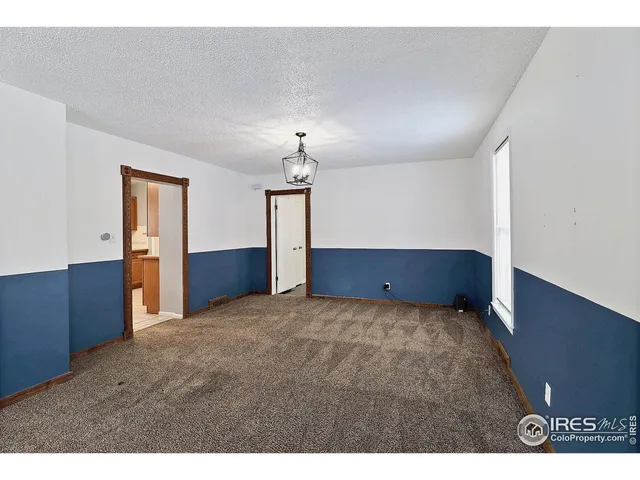 a view of an empty room with a cabinet