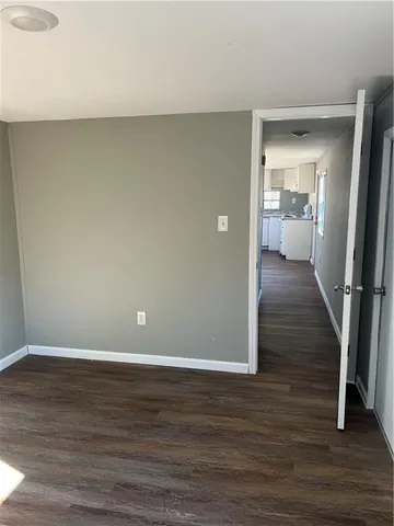 a view of a room with wooden floor