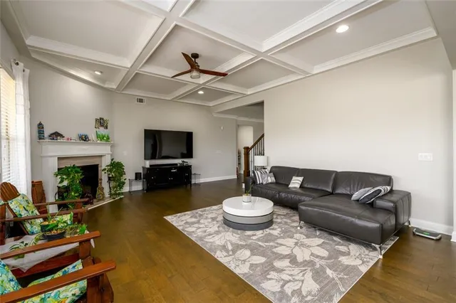 a living room with furniture fireplace and a large window
