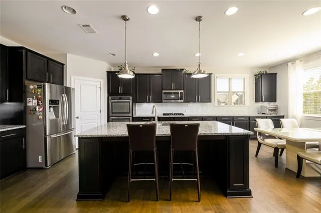 a kitchen with granite countertop stainless steel appliances and wooden cabinets