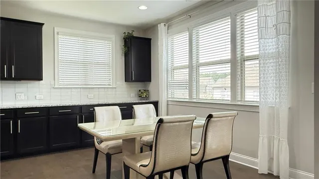 a kitchen with stainless steel appliances cabinets and a window