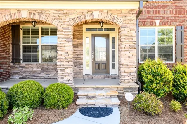 a front view of a house with a garden