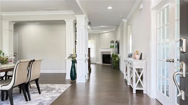 a view of a hallway with furniture and wooden floor