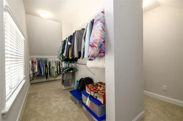 a bathroom with a granite countertop tub sink and mirror