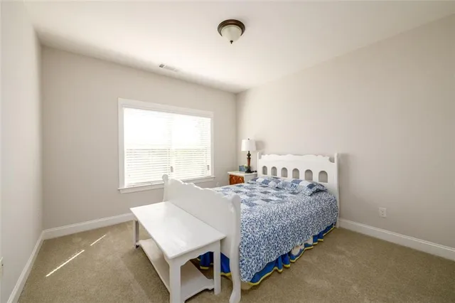 a bathroom with a granite countertop sink a mirror and a bathtub