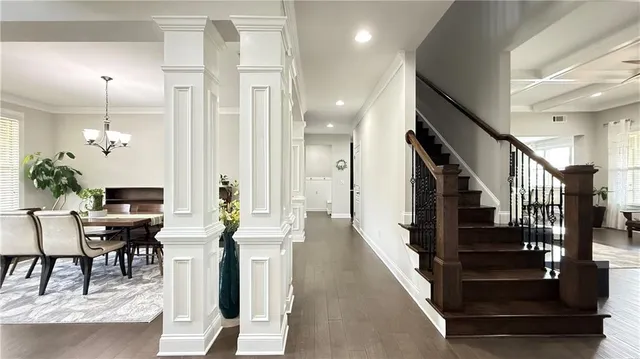 a view of entryway and hall with wooden floor