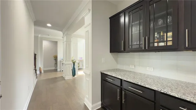 a kitchen with granite countertop cabinets and black appliances