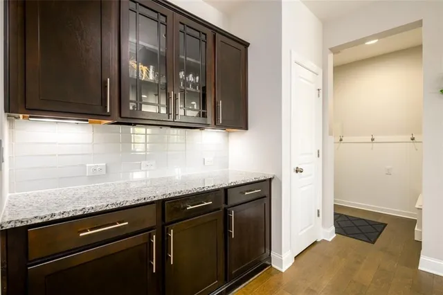 a living room with furniture fireplace and a large window