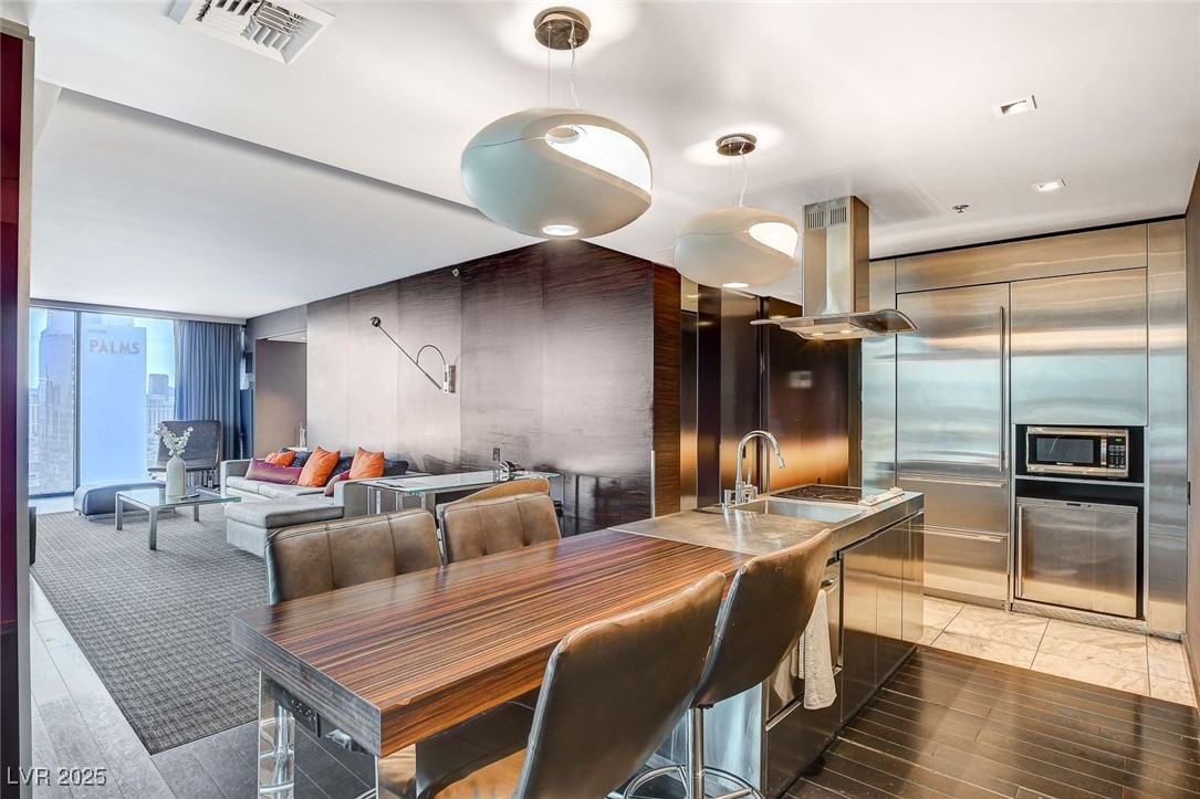 4381 West Flamingo Road, Unit 2202 Las Vegas, NV 89103 - Photo 14 of 40 Dining area with floor to ceiling windows and light wood-type flooring